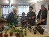 Photo 1: Daytime Gardener Brenda Howlett assists True and Kingsley Cramer select plants while Pat Cramer watches.		  
