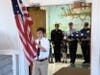 Saint Columbkille grade 6 student Michael Upton led the procession for the flag ceremony, that included parents, alumni and active and retired service members.