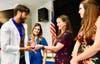 PLTW teachers present awards of achievement during the White Coat Ceremony held on April 23. 