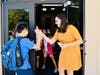 High Fives! Chaparral Middle School orchestra teacher Taylor Harb welcomes young musicians on August 12. 