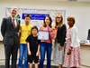 Chaparral Middle School parent volunteer Amy Hou receives the Partner in Education Award on Oct. 16. Shown with Principal Ron Thibodeaux, Board President Helen Hall, Assistant Principal Denise Loera, and children. 