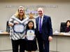 Maple Hill Elementary 4th grader Irene Park honored as holiday art contest winner. Shown with Principal Kelly Morris and Board President Larry Redinger.