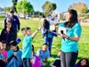 Walnut Elementary third grader Tyler Liu is rewarded for reaching the 75-mile mark by his coach (and mom) Natalie Liu. 