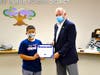 Board President Larry Redinger presents Super Star Student Award to Vejar 4th grader Angel Bennett.