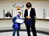 Board President Layla Abou-Taleb salutes Castle Rock second grader Christopher Oberholtzer Ballesteros with Super Star Student Award.