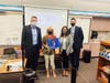 Superintendent Dr. Robert Taylor, Special Education Director Emiko Chapman, and Human Resources Director Dr. Seth Bond present retirement gifts to Westhoff Elementary Education Specialist Joann Goebel. 