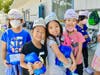 Walnut Elementary second graders pose with first day of school hats and supplies. 