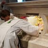 The Bishop placed the box of reliquaries inside the altar.  It was then sealed closed.