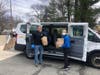 West Suburban YMCA Sports Director Chris Ellison and Chief Operating Officer Kim Benzan deliver bags of groceries to Newton residents.
