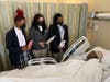 The students read their letters of well wishes to several patients.