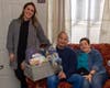 Maggie Kolesar (far left), Move 4 Less general sales manager, surprised Calvin Kuehl with a $1,000 Visa gift card and basket of goodies for his Community Smiles win. Also pictured is his wife Elaine. 