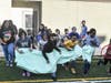 Youth at the Boulder Highway Clubhouse run through the breakthrough banner to start using their new multi-sport field, the result of a gift from the Shaquille O'Neal Foundation and Reebok.
