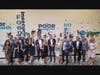 The Junior Achievement of Southern Nevada board of directors stands in front 
of the barrier breaking wall after event participants hammered through various obstacles to student success. 
