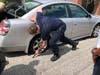 Three EMS crewmen and Cpl. Chris Campbell of the Brookfield PD and off-duty at the time stepped up to help change an elderly woman's tire.