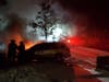 Danbury firefighters battle a car fire in the midst of a snow storm on Saturday night.