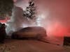 Danbury firefighters battle a car fire in the midst of a snow storm on Saturday night.