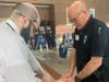 Weston EMT John Loeser shows a Weston High School teacher how to "Stop the Bleed"