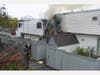 Danbury Fire Department first responders reported heavy smoke and flames showing from the rear of a two-story multi-family building on Bells Place Monday morning.