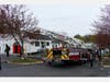 Danbury Fire Department first responders reported heavy smoke and flames showing from the rear of a two-story multi-family building on Bells Place Monday morning.