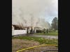 First responders found all occupants safely evacuated and a fire in the attached garage with smoke throughout the entire house.