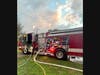 First responders found all occupants safely evacuated and a fire in the attached garage with smoke throughout the entire house.