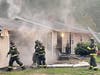 First responders found all occupants safely evacuated and a fire in the attached garage with smoke throughout the entire house.