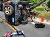 After hitting the pole, the SUV rolled over, trapping the driver, according to the Danbury Fire Department.