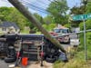 After hitting the pole, the SUV rolled over, trapping the driver, according to the Danbury Fire Department.