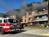 First responders reported heavy smoke​ pouring from a third floor balcony slider and numerous people trying to evacuate. 
