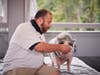 Jeremy Beatrice, a business teacher at George Washington High School, knew what to do when he met a pot-bellied pig named Raines at TruMark Financial’s Kiss-Or-Feed-A-Pig Financial Literacy Fundraiser. 