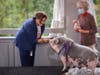 Nilda Ruiz, President and CEO, Asociación Puertorriqueños en Marcha, Inc. (APM) fed a pot-bellied pig named Raines at TruMark Financial’s Kiss-Or-Feed-A-Pig Financial Literacy Fundraiser held at the Abington Art Center.