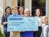 Karen Schneider (center) presents the SJFC Members and Event Volunteers with the Lois Schneider Realtor event donation. 