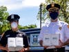 Officer Delgado and Inspector Scrima of the 2nd Precinct receive face masks