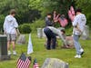 Young volunteers placing flags at Lakeview Cemetery
