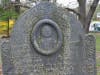 Gravestone of the Reverend Thomas Jones, second Minister of the the Second parish Meetinghouse. Notice the effects of acid rain and the environment on the slate, as well as vandalism .