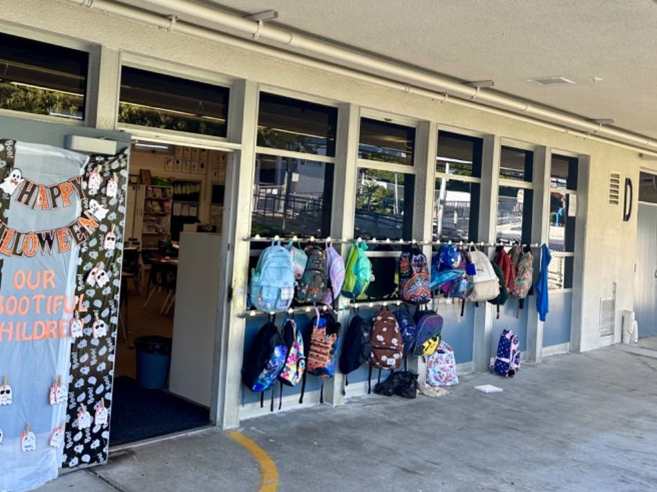 Backpacks line the exterior of one of the colorful and welcoming classrooms at the 1961 campus of Palisades Elementary in Capistrano Beach.  