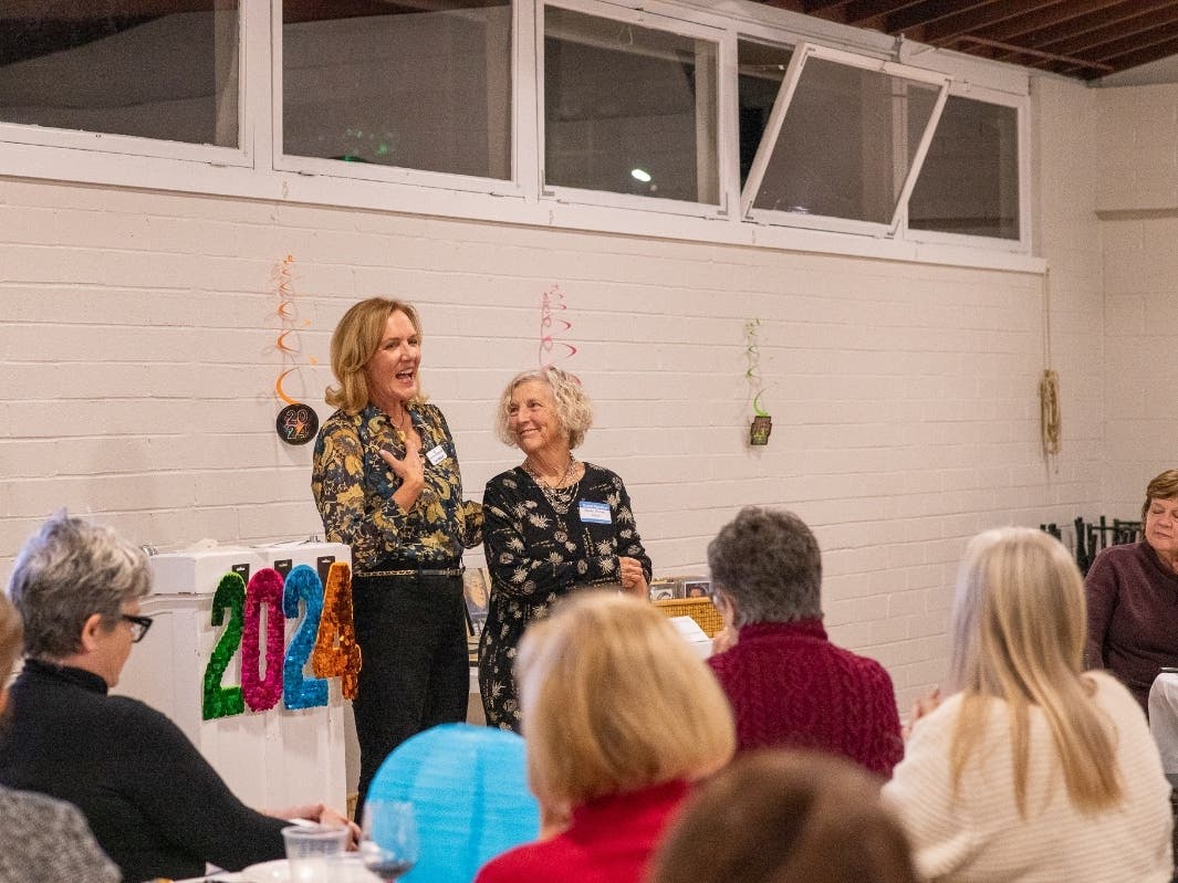 Artist Hedy Buzan is thanked by DPWC First Vice President Toni Nelson and an appreciative audience. 