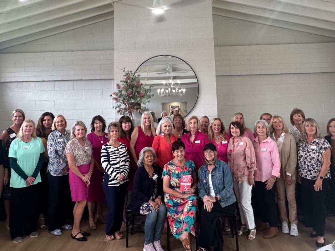 Dana Point Women’s Club members gather at Community House to learn more about breast cancer and show support for member Leann Rodowicz, seated in front row, right. 
