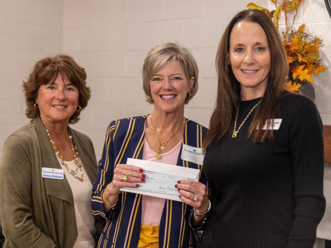 From left, DPWC Treasurer Donna Childress and First Vice President Judy Amiano present a donation to Debby Thrailkill, founder of My Own - A Case for Kids. 