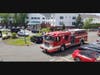 A Manchester Fire Department fire engine passes by the entrance of Arbors of Hop Brook Life Plan Retirement Community adjacent to Manchester Manor on Tuesday, May 11, in a celebratory "Thank You Parade" as part of National Skilled Nursing Care Week. 