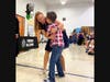 Liz Duclos hugs her son during an assembly this week. 
