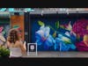 Teagan admires a mural of flowers.