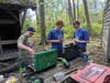 Rusty Guathier, George Gregory and Ethan Lutz cook their main course