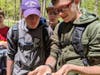 Ethan Lutz cradles a baby turtle he found during a hike
