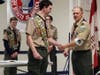 Eagle Scout, Nate Nemth is congratulated by Troop 200 Scout Master, Jeff Lutz for earning his 101st merit badge, setting a new troop record.