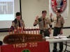 Star Scout, Owen Maslanka lights the Scout Oath candles as Senior Patrol Leader, Andrew Bozzi and Alex Senger look on.