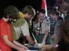 Ryan Senger and other scouts from Troop 200 look at the troop's scrapbooks and other historical items.