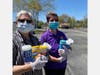 Sister Rosario (Left) and Sister Zena (Right) handing out Clorox wipes to students and parents as they drive through campus. 