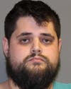 Andre Origlio, 29, faces 29 charges, including possession of an assault weapon, machine gun, and class D distribution.