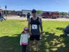 Tim Baxter hung out with his daughter after winning Saturday's 5K.